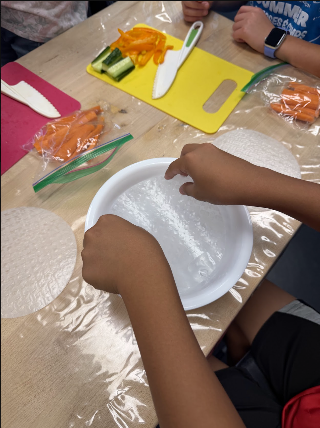 Learning to soften rice paper — soaking it just long enough before rolling