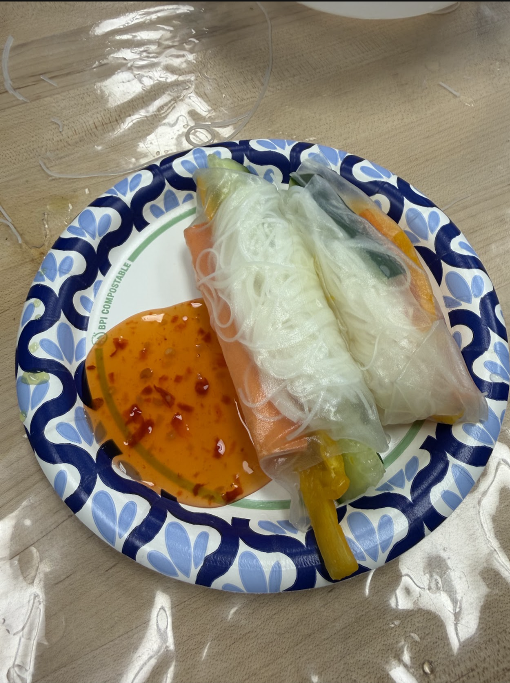 Finished spring roll served with sweet chili dipping sauce — made entirely by the students